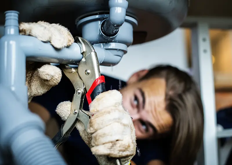 plumber under the sink